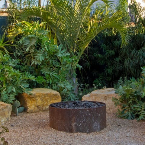 Sit on the boulders in the landscaped garden and light the fire pit