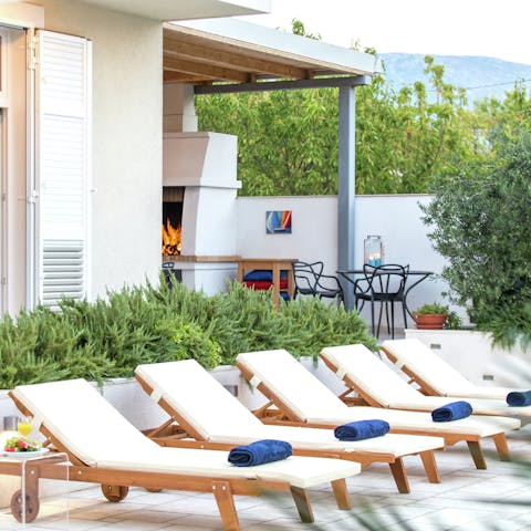 Settle in for a sunbathing session on the poolside loungers
