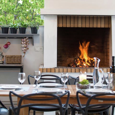 Light the fire pit for a flame-grilled dinner on the terrace