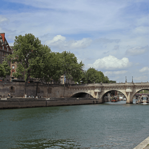 Enjoy a relaxing stroll by the River Seine, soaking up the Parisian sunshine