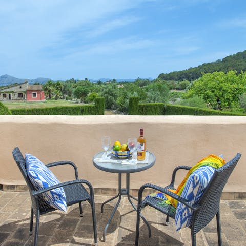 Share a bottle of sparkling on your balcony overlooking the luscious landscape