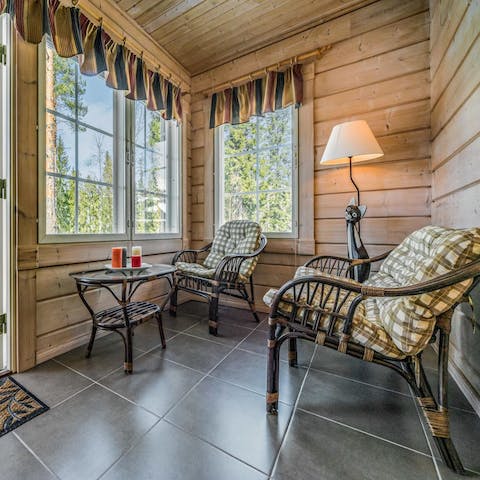 Enjoy your morning coffee with a view of the woods in the sunroom