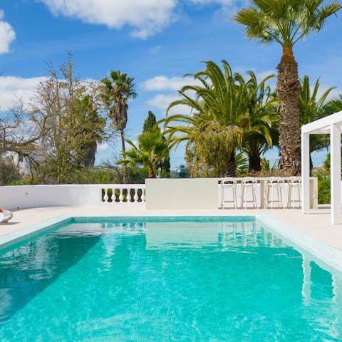 Savour lazy days at home lounging by the swimming pool