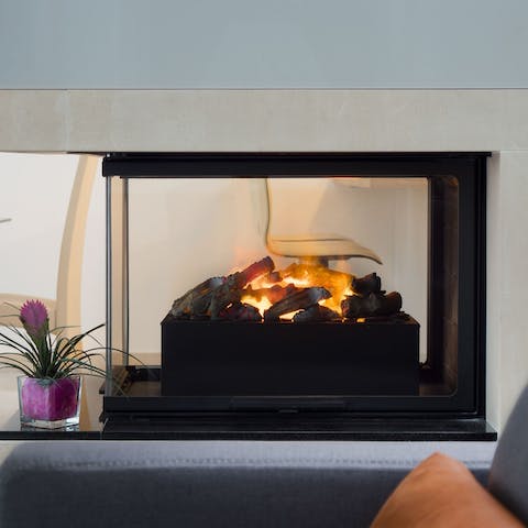 Turn on the contemporarily styled fireplace and get toasty come evening