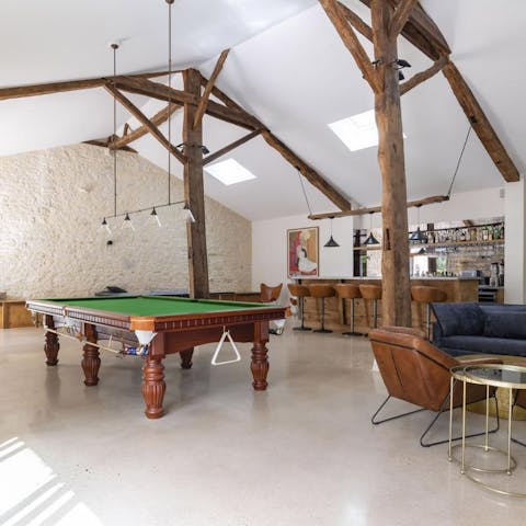 Pour yourself a tipple at the bar before playing a game of pool