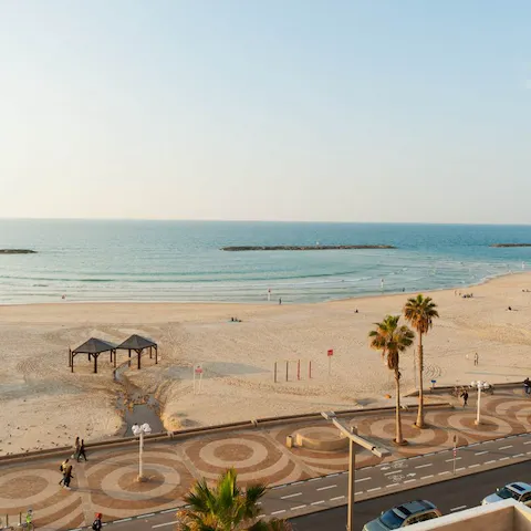 Cross over the street to reach Aviv Beach and swim in the Mediterranean Sea