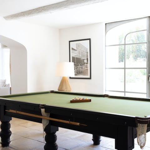 Set up for games of pool in the sun-filled games room