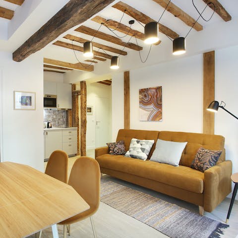 Kick back and relax in the cosy living room after a long day exploring, admiring the rustic beams