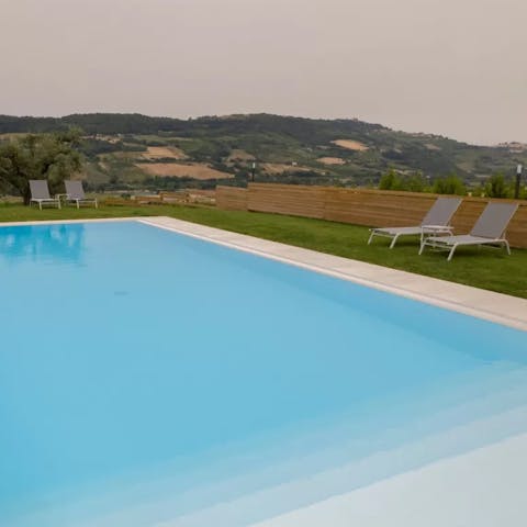 Swim laps in the private pool with views over the Aso valley