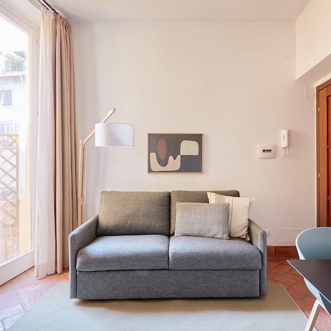 Kick back and relax with a glass of Italian wine in the bright living room after a day of Rome sightseeing
