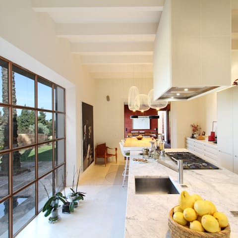 Prepare a Balearic feast in the kitchen as the soft Mediterranean light floods in through the floor-to-ceiling windows