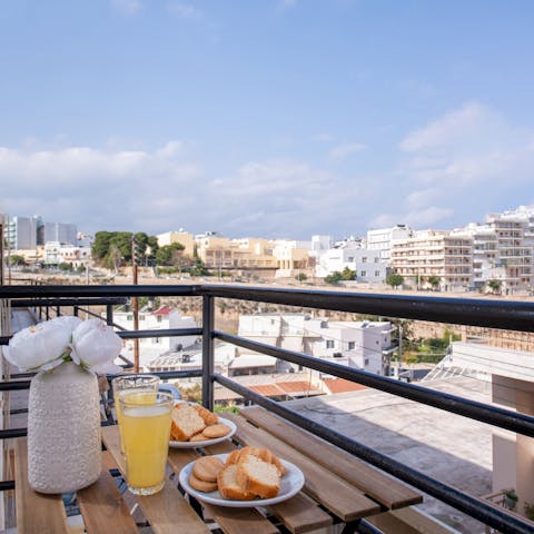 Toast a happy holiday on the balcony with a glass of traditional ouzo