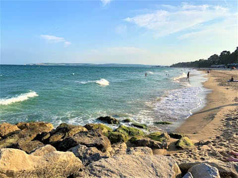 Visit the soft sands of Sandbanks Beach, a ten-minute drive away