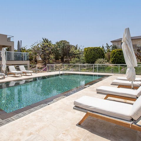 Splash about in the villa's swimming pool and dry off on one of the loungers