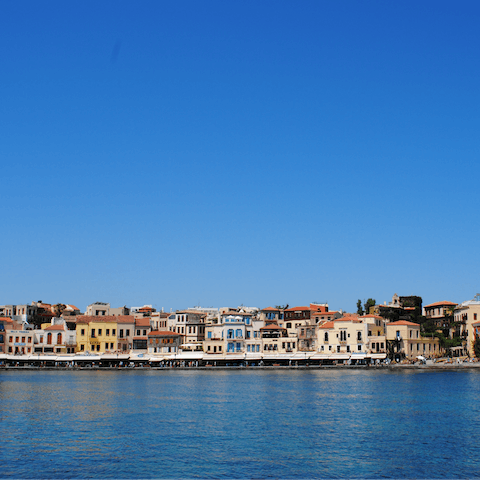 Walk along Chania's historic harbour, only half an hour's drive away