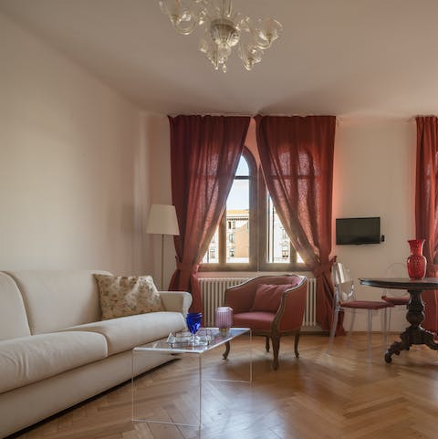 Relax in the living room overlooking the Grand Canal