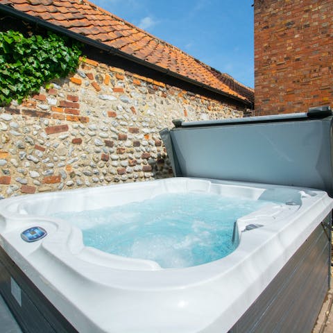 Relax with a glass of bubbly in the private hot tub after a long walk on the beach