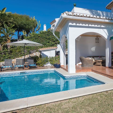 Go for a dip in the pool to escape the heat, or relax on the sun loungers under the parasol