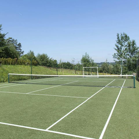 Challenge loved ones to a game of tennis on the private court