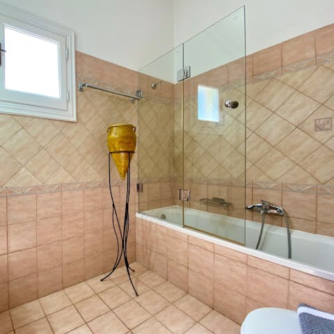 Finish a wonderful day with a relaxing soak in the tiled bathtub