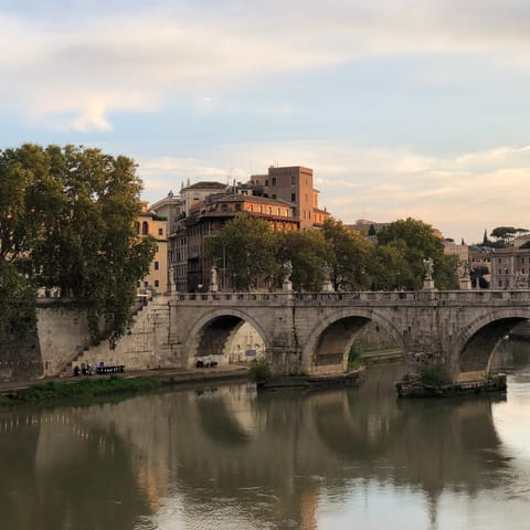Enjoy a long walk along the Tiber, admiring Rome's many bridges