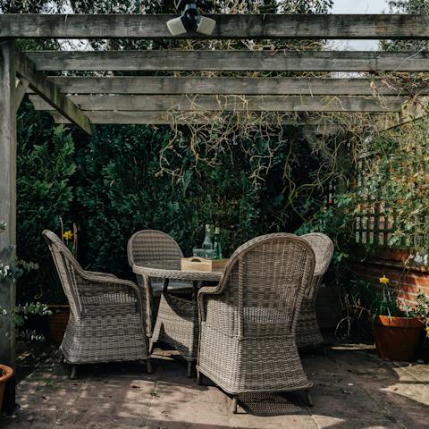 Spend your down time under the lush, earthy pergola 