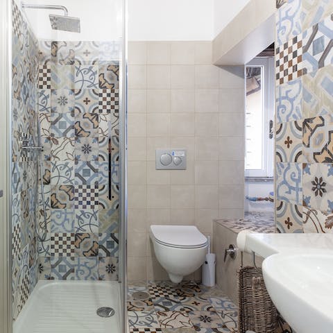 Begin each day with a relaxing soak under the tiled bathroom's rainfall shower