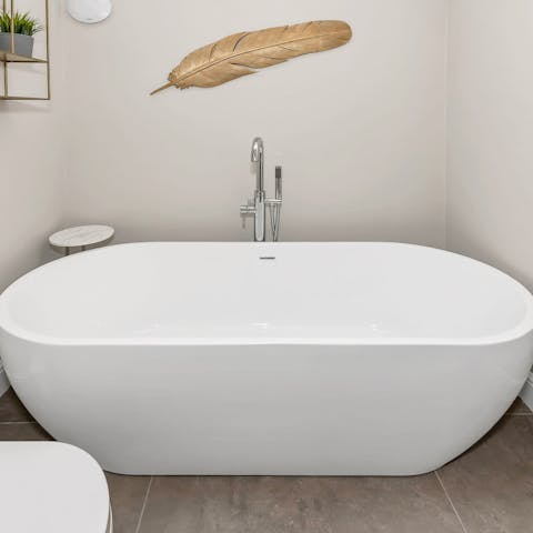 Unwind with a long soak in the standalone bathtub