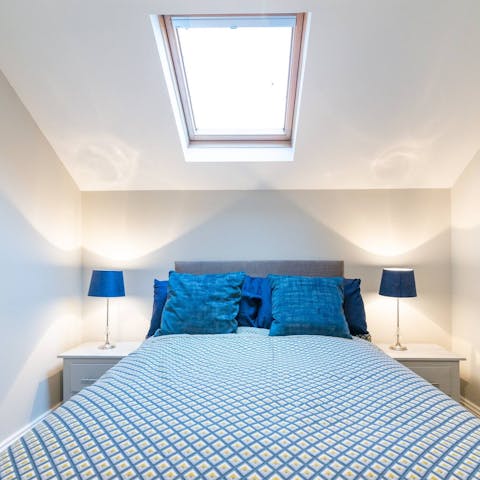 Fall asleep under the star-studded skylight in the second bedroom