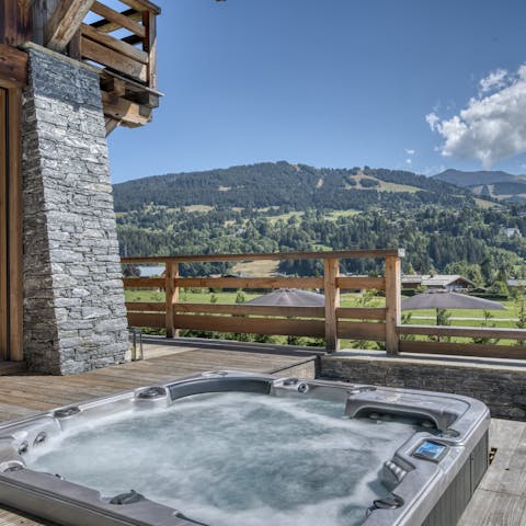 Take in the Alpine valley view from the bubbling warmth of the hot tub
