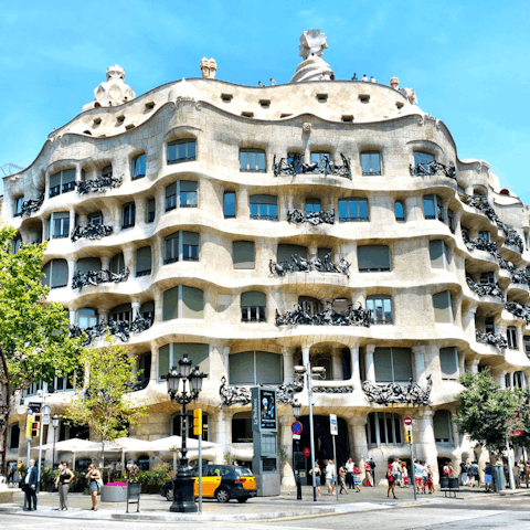 Walk up to the iconic Casa Mila and admire the striking historic architecture