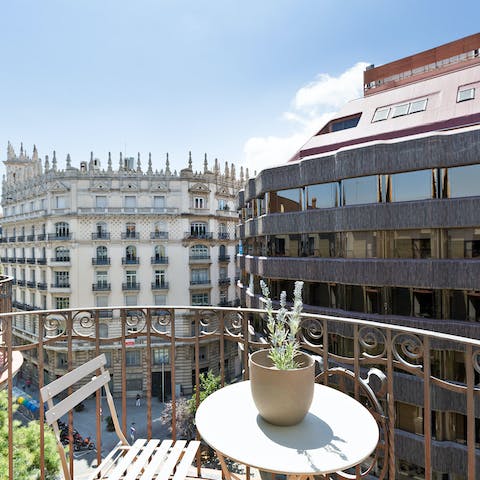 Sit out on the private balcony and look down at the busy streets below