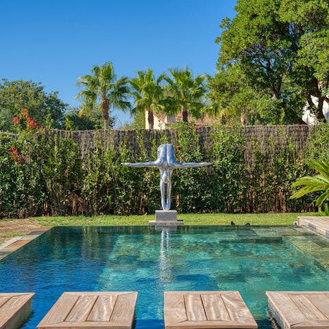 Step across the shimmering swimming pool in the zen-like garden