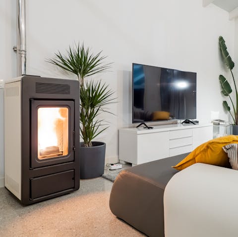 Cosy up in the open-plan living area around the fireplace for a movie night everyone can enjoy