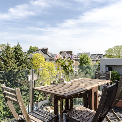 Enjoy an alfresco lunch on the balcony with its views over Belsize Park's leafy gardens