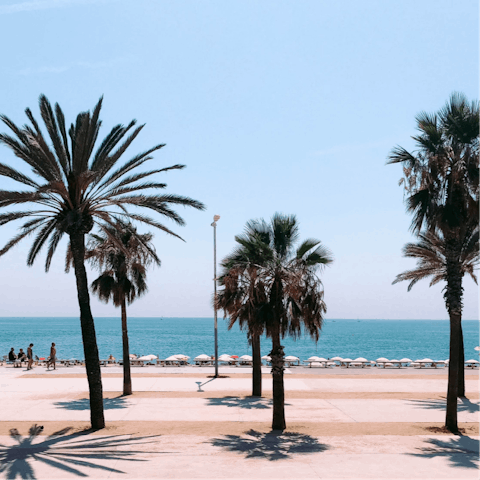 Take a fifteen-minute walk to Barceloneta beach for a day of sunbathing