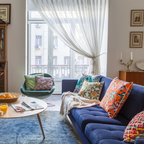 Relax in the bright living room with a glass of Portuguese wine after a day of exploring the city