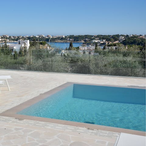 Spend relaxing days by the swimming pool with views across the natural harbour
