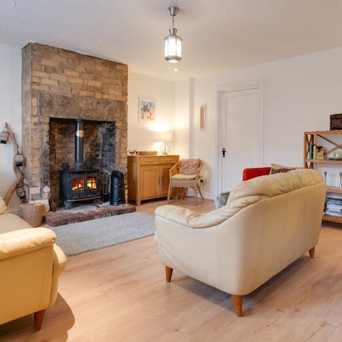 Snuggle up in front of the log burner after a walk by the sea