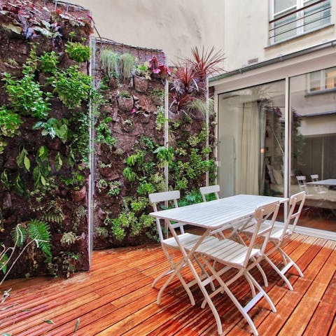 Enjoy fresh air out on the beautiful patio surrounded by the vibrant living walls