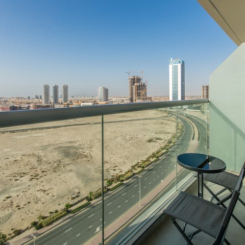 Admire sweeping views of the skyline against the desert from your balcony