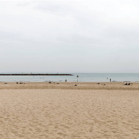 Take a stroll along the golden sands of Charles Clore Beach
