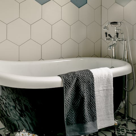 Unwind at the end of a long day in the luxurious roll top bath