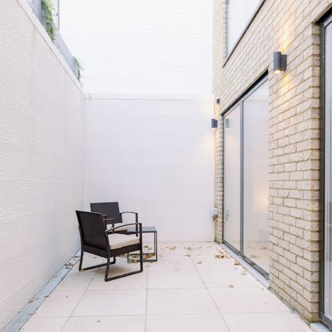 Relax with a glass of wine in the private courtyard after a busy day in London