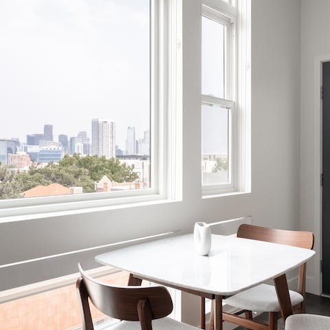 Feast on Denver skyline views while enjoying a meal at the window-side table