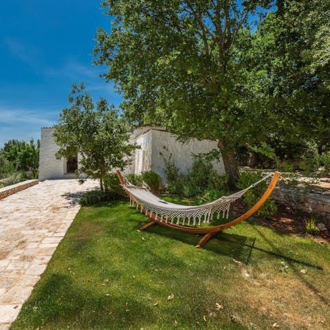 Recline beneath and olive tree on the macrame hammock