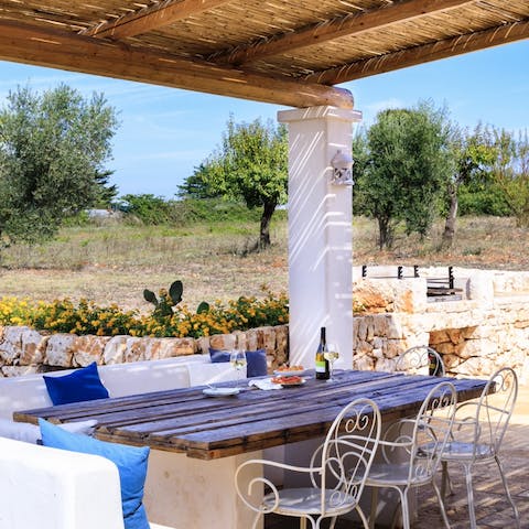 Dine alfresco on the shaded terrace, surrounded by greenery