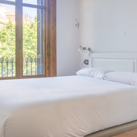 Wake up to Juliet balcony views of your El Born neighbourhood from the chic, minimalist bedrooms