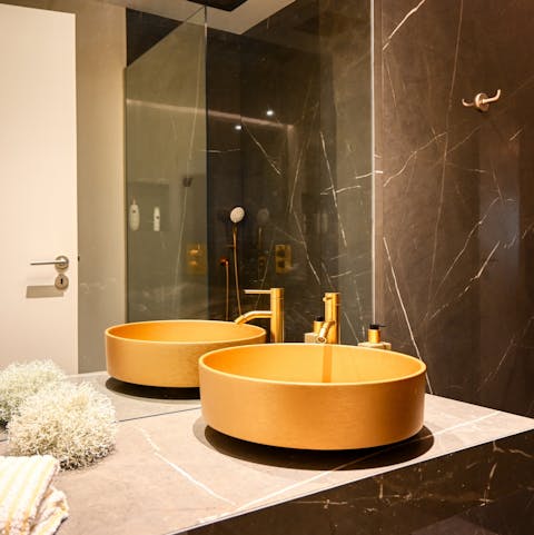 Get ready for a night out in the sleek, marble en-suite bathroom