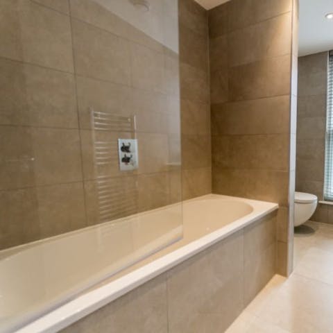Treat yourself to a reinvigorating soak in the apartment's bathtub
